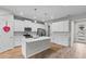 Spacious and bright kitchen featuring white cabinetry, an island, and stainless steel appliances at 4212 Cloud Hopper Way, Lutz, FL 33559