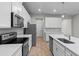 Bright kitchen featuring white countertops, stainless steel appliances, and ample cabinet space at 4212 Cloud Hopper Way, Lutz, FL 33559