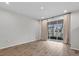 Neutral living space with sliding glass doors leading to backyard at 4212 Cloud Hopper Way, Lutz, FL 33559
