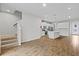 Open living space featuring wood-style flooring, bright white walls and natural lighting at 4212 Cloud Hopper Way, Lutz, FL 33559