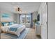 Serene main bedroom featuring a plush bed, elegant furnishings, and tranquil blue accents at 4212 Cloud Hopper Way, Lutz, FL 33559