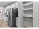The large pantry features shelves and a hanging rack for extra storage at 4212 Cloud Hopper Way, Lutz, FL 33559