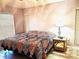 Bedroom with a floral pattern queen bed, a bedside table and a window at 4275 Castlebridge Ln # 1325, Sarasota, FL 34238