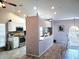 Open kitchen with white cabinetry, stainless steel appliances, and wood-look tile flooring at 4275 Castlebridge Ln # 1325, Sarasota, FL 34238