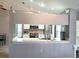 Well lit kitchen has white cabinets, tiled backsplash and stainless steel appliances at 4275 Castlebridge Ln # 1325, Sarasota, FL 34238
