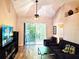 Comfortable living room featuring vaulted ceilings, wood-look floors, and bright natural light at 4275 Castlebridge Ln # 1325, Sarasota, FL 34238
