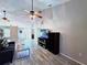 Bright living room with a large ceiling fan, a comfortable couch, and an entertainment center at 4275 Castlebridge Ln # 1325, Sarasota, FL 34238
