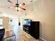 Spacious living room featuring wood floors, ceiling fan, and entertainment center at 4275 Castlebridge Ln # 1325, Sarasota, FL 34238