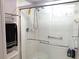 Bathroom with a glass enclosed shower and tiled walls at 4275 Castlebridge Ln # 1325, Sarasota, FL 34238