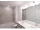 Elegant bathroom boasts a dual sink vanity, tub-shower combo, and stylish fixtures for a luxurious feel at 434 Albatross Rd, Rotonda West, FL 33947