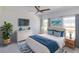 Bright bedroom features a ceiling fan, ensuite bathroom, and beach-themed decor at 434 Albatross Rd, Rotonda West, FL 33947