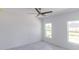 Bedroom features two bright windows and ceiling fan at 434 Albatross Rd, Rotonda West, FL 33947