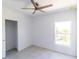 Cozy bedroom with a ceiling fan, tile floors, closet and a window providing natural light at 434 Albatross Rd, Rotonda West, FL 33947