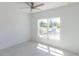 Bright bedroom featuring tile floors, a ceiling fan, and a window offering ample natural light at 434 Albatross Rd, Rotonda West, FL 33947