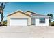 Charming one-story home features a two-car garage and a sunny yellow exterior at 434 Albatross Rd, Rotonda West, FL 33947