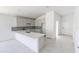 Bright kitchen features gray cabinets, a long island, stainless steel sink, and tile floors at 434 Albatross Rd, Rotonda West, FL 33947