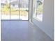Bright living room features tile floors, white walls, and sliding glass doors at 434 Albatross Rd, Rotonda West, FL 33947