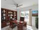 Well-appointed home office featuring custom built-ins, a spacious desk, and a serene window view at 434 Albatross Rd, Rotonda West, FL 33947