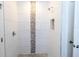Shower stall features white tiles with decorative stripe at 434 Albatross Rd, Rotonda West, FL 33947