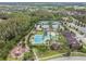 Aerial view showcases the community pool, tennis courts, clubhouse, and lush landscaping, highlighting the amenities at 4849 Isola Ct, Wesley Chapel, FL 33543
