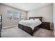 Comfortable bedroom with plush carpet, a large bed and lots of natural light from the windows at 4849 Isola Ct, Wesley Chapel, FL 33543