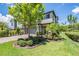 Charming two-story home with a paved driveway and a well-manicured lawn with lush landscaping at 4849 Isola Ct, Wesley Chapel, FL 33543