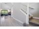 Hallway view with ceramic tile flooring and a carpeted staircase leading to the second floor at 4849 Isola Ct, Wesley Chapel, FL 33543