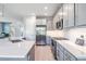 Bright kitchen featuring stainless steel appliances, light grey cabinets and light countertops at 4849 Isola Ct, Wesley Chapel, FL 33543