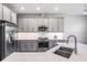 Bright kitchen featuring stainless steel appliances, light grey cabinets and light countertops at 4849 Isola Ct, Wesley Chapel, FL 33543