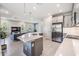 This spacious kitchen features an open layout connecting to the living room, stainless steel appliances, and a large center island at 4849 Isola Ct, Wesley Chapel, FL 33543