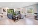 Spacious living room with tile flooring and a sliding door to the outside, providing lots of natural light at 4849 Isola Ct, Wesley Chapel, FL 33543