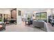 Open-concept living room with a large window, stylish furnishings, and ceramic tile flooring at 4849 Isola Ct, Wesley Chapel, FL 33543
