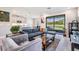 Open-concept living room with dining area, providing lots of light and with views of the pond at 4849 Isola Ct, Wesley Chapel, FL 33543