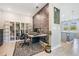 Well-lit office with custom shelving, a brick accent wall, and sleek desk, perfect for a productive work environment at 4849 Isola Ct, Wesley Chapel, FL 33543