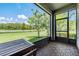 Relaxing screened patio offers a scenic view of the pond and natural landscape, perfect for outdoor enjoyment at 4849 Isola Ct, Wesley Chapel, FL 33543