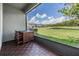 Screened patio with table and chairs overlooking a pond and neighborhood providing a peaceful outdoor living space at 4849 Isola Ct, Wesley Chapel, FL 33543