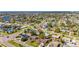 Expansive aerial view of a charming neighborhood, showcasing a network of canals and waterfront properties with easy access to the water at 564 Florida S Cir, Apollo Beach, FL 33572