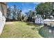 Backyard features green grass, shed, and lush trees at 564 Florida S Cir, Apollo Beach, FL 33572