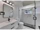 Modern bathroom featuring a glass-enclosed shower and sleek vanity with black accents at 564 Florida S Cir, Apollo Beach, FL 33572