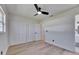 Bright bedroom featuring new wood floors, ceiling fan, and ample closet space at 564 Florida S Cir, Apollo Beach, FL 33572