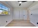 Bright bedroom featuring new wood floors, ceiling fan, and a sunny window view at 564 Florida S Cir, Apollo Beach, FL 33572
