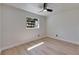 Bright bedroom with large window, light hardwood floors, and neutral walls, creating a relaxing atmosphere at 564 Florida S Cir, Apollo Beach, FL 33572