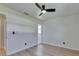 Bright bedroom featuring new wood floors, ceiling fan, and multiple doorways at 564 Florida S Cir, Apollo Beach, FL 33572