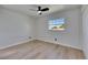 Bright bedroom featuring new wood floors, ceiling fan, and window for natural light at 564 Florida S Cir, Apollo Beach, FL 33572