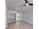 Spacious bedroom with a modern ceiling fan, closet, and light hardwood floors, creating a bright and airy space at 564 Florida S Cir, Apollo Beach, FL 33572