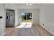 Bright dining room with light wood floors and sliding doors to the backyard and view to the kitchen at 564 Florida S Cir, Apollo Beach, FL 33572