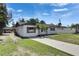 Charming single-story home with a green lawn and mature palm trees at 564 Florida S Cir, Apollo Beach, FL 33572