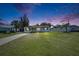Beautiful one-story home with a lush green lawn under a colorful evening sky at 564 Florida S Cir, Apollo Beach, FL 33572