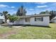 Single-story home with palm trees in the front yard and well-maintained lawn at 564 Florida S Cir, Apollo Beach, FL 33572