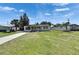 Well-maintained single-story house with a green lawn and mature palm trees in the front yard at 564 Florida S Cir, Apollo Beach, FL 33572